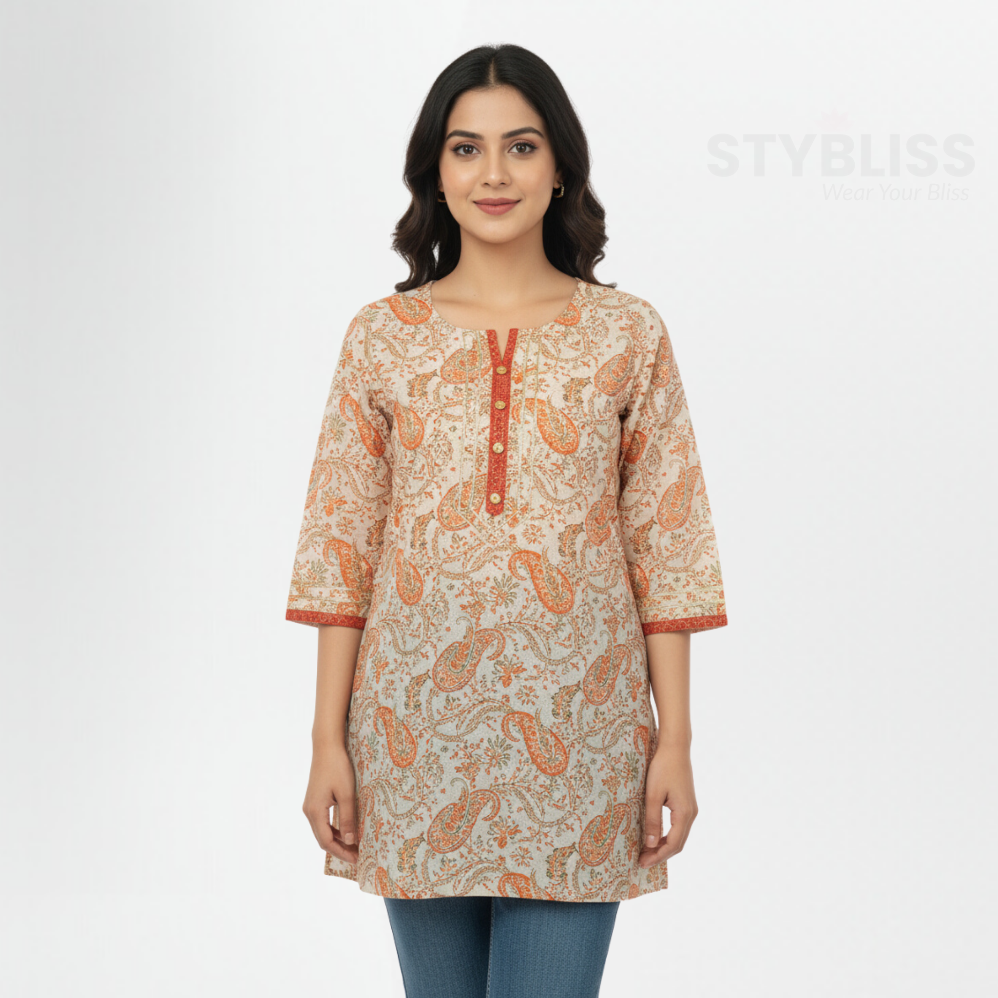 Woman wearing a patterned beige and orange kurta with blue jeans on a white background, branded 'Stybliss'.